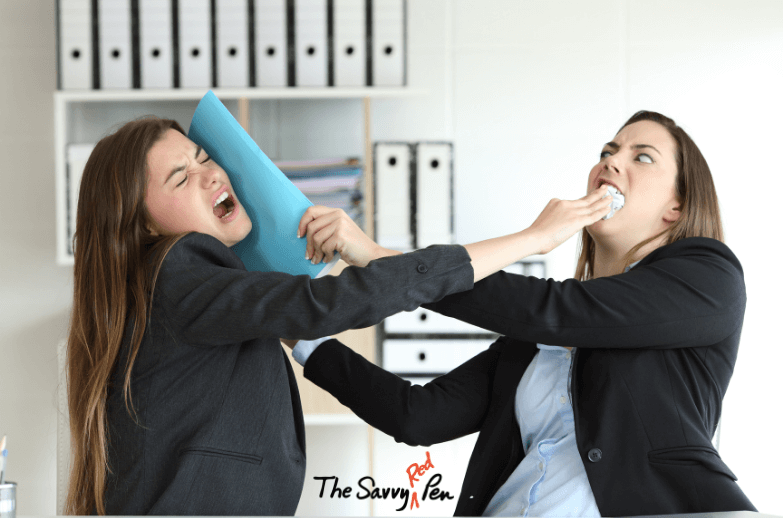 The Oxford Comma Debate. Two business women engage in hand to hand combat using office supplies as weapons. The Savvy Red Pen logo appears at the bottom between them.